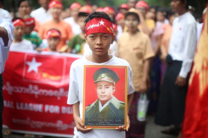 A young supporter holds the picture of Aung San, father of Aung San Suu Kyi and Myanmar's founding father, on Martyrs' Day commemorations in Yangon, July 19, 2015. (PHOTO - Myanmar Now/ Hkun Lat)