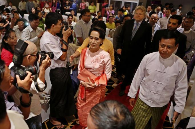 Daw Aung San Suu Kyi (L) and Information Minister U Ye Htut (R) arrive at a meeting to celebrate International Press Freedom Day in Yangon. Photo: Lynn Bo Bo/EPA