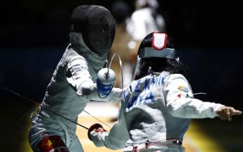 Luu Thi Thanh Nhan of Vietnam (Back) fights with Kyaw May Tinzar of Myanmar (Front) during their Fencing Women's Team Foil quarterfinals of the SEA Games 2015 in Singapore, 06 June 2015. EPA/WALLACE WOON