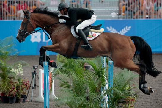 Phyo Tun Aung of Myanmar in action during the equestrian jumping qualifiers at the 28th SEA Games in Singapore, 08 June 2015. EPA/WALLACE WOON