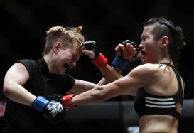 Jenny Huang (R) of Taiwan in action against Elena Pashnina (L) of Russia during their Mixed Martial Arts (MMA) One Championship fight in Yangon, Myanmar, 18 July 2015. Jenny Huang won the bout.