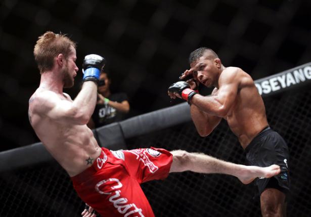 Bibiano Fernandes (R) of Brazil in action against Toni Tauru (L) of Finland during their Mixed Martial Arts (MMA) One Championship fight in Yangon, Myanmar, 18 July 2015. Fernandes won the match defending his Bantamweight world championship title.