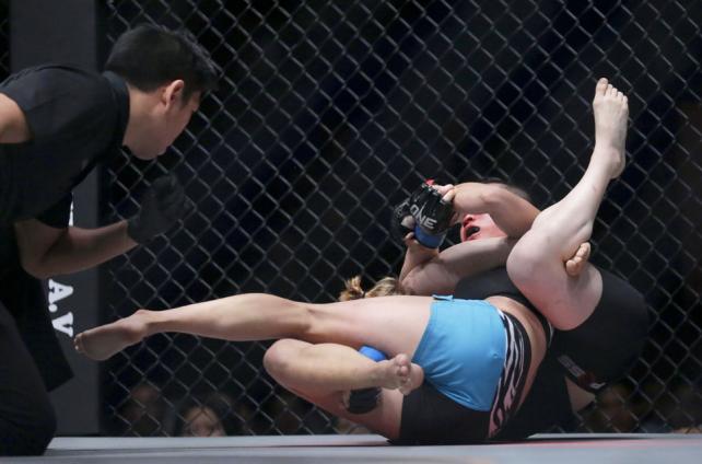 Jenny Huang (front) of Taiwan in action against Elena Pashnina (back) of Russia during their Mixed Martial Arts (MMA) One Championship fight in Yangon, Myanmar, 18 July 2015. Jenny Huang won the bout.