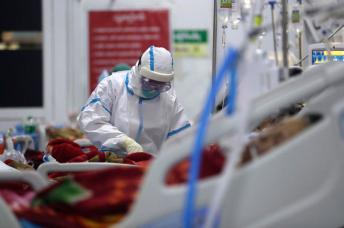 A medical worker wearing PPE (Personal protective equipment) attends to a patient at COVID-19 ICU (Intensive care unit) of Yangon General Hospital, in Yangon, Myanmar. Photo: EPA