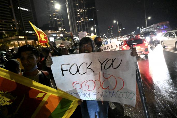 Protestors take part in a demonstration against the economic crisis at the entrance of the president's office in Colombo on April 11, 2022. Photo: AFP