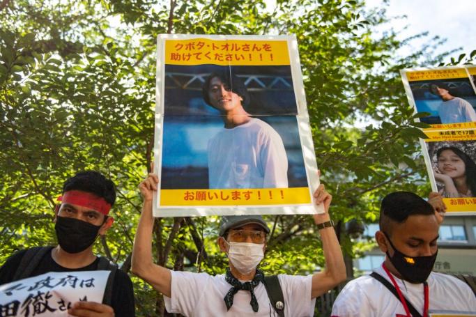 A group of activists hold placards of Japanese citizen Toru Kubota, who is detained in Myanmar, during a rally in front of the Ministry of Foreign Affairs in Tokyo on July 31, 2022. Photo: Philip FONG / AFP