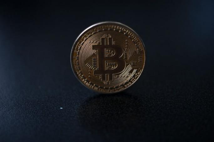 A souvenir coin depicting a bitcoin is pictured in Caracas on September 17, 2021. Photo: AFP