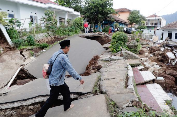A man walks past a collapsed Islamic boarding school caused by a 5.6 magnitude earthquake, in Cianjur, Indonesia, 23 November 2022. Photo: EPA