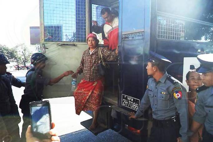 The 14 Michaungkan demonstrators arrive at court in Kyauktada Township on the afternoon of February 26, 2015. Photo: Nan Myint/Mizzima
