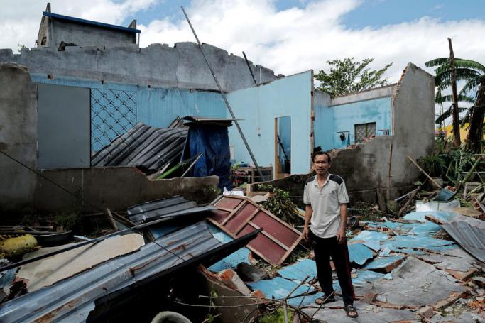 A man inspects his house after it was damaged by Typhoon Molave, in Quang Nam, Vietnam, 29 October 2020. Photo: EPA