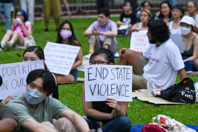 Attendees holding signs during a protest against the death penalty at Speakers’ Corner in Singapore in April. Photo: AFP