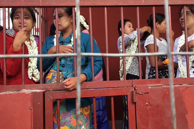 Detained farmers look on from a holding cell at a courthouse in Sintgaing in Mandalay region on January 10, 2017. Twenty-one farmers were granted bail by a Myanmar court on January 10 after being jailed over a land-grab dispute with the military that has highlighted acute challenges faced by the rural poor. Sixteen of those detained were women, according to a family member, including one who was taken to jail along with her six-month-old baby. Photo: Kyaw Zay Win/AFP
