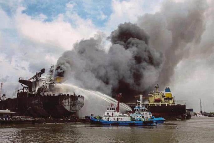 Fire fighters onboard a vessel try to extinguish a fire on a tanker ship docked in Belawan on May 11, 2020. Photo: Ivan Damanik / AFP