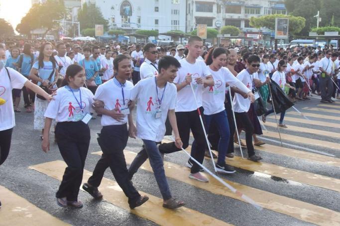 The visually impaired people participate in the 28th International White Cane Day event in Yangon yesterday. Photo: MNA
