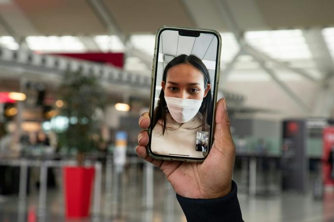 Myanmar Beauty queen Han Lay speaks by video call during her arrival at Toronto Pearson International Aiport while she waits for a connection fly to Charlottetown in Toronto, September 28, 2022. Han Lay, a beauty queen from Myanmar who sought refuge in Thailand after criticising the military junta in her homeland has been granted asylum in Canada. (Photo by Jorge Uzon / AFP)