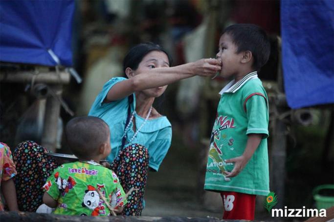 A mother feeding her baby at a refugee camp in Kachin State. Photo: Mizzima
