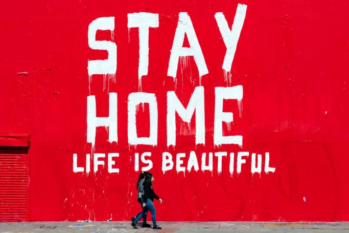 (File) Two women wearing face masks walk past a mural reading 'Stay Home Life Is Beautiful' amid the coronavirus pandemic in Los Angeles, California, USA, 07 April 2020. Photo: EPA