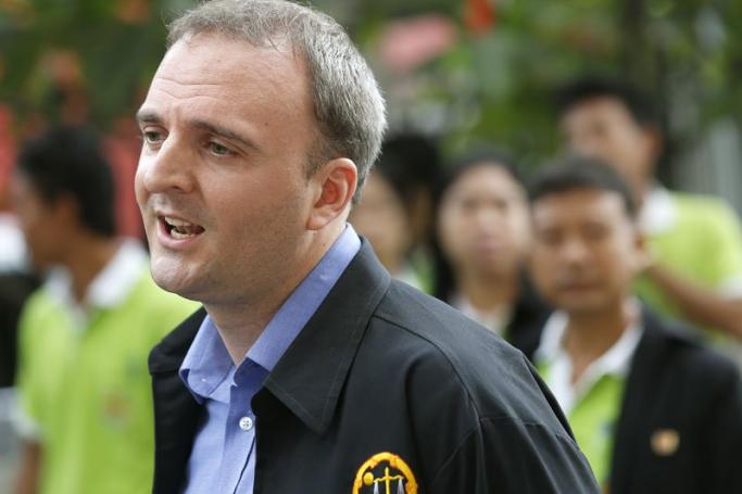 British migrant workers rights activist Andy Hall talks to media as he arrives for his trial at the Phra Khanong Provincial Court in Bangkok, Thailand, 02 September 2014. Photo: Narong Sangnak/EPA
