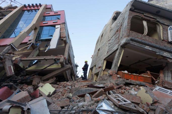 Rescue team members walk on a collapsed house after another powerful earthquake struck, in Kathmandu, Nepal, 12 May 2015. Photo: EPA
