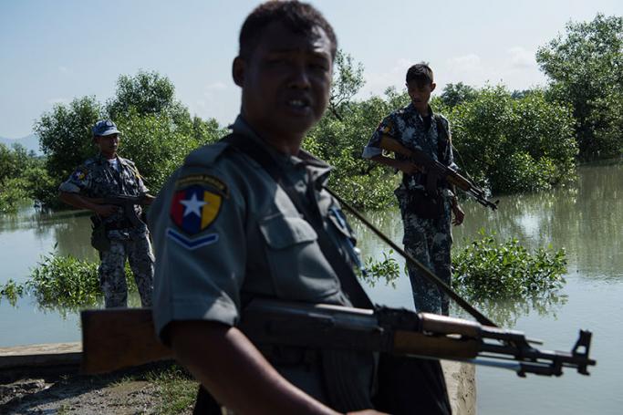 Armed Myanmar border guard patrol the border area along the river dividing Myanmar and Bangladesh located in Maungdaw, Rakhine State in October following attacks that killed nine border police. Photo: Ye Aung Thu/AFP
