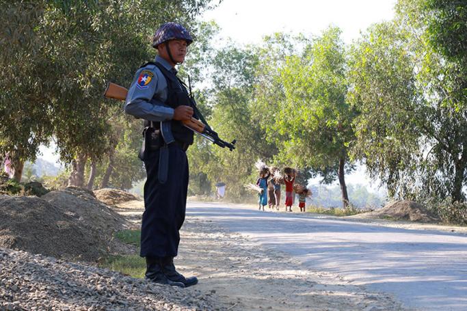 An armed Myanmar police officer on the road in Buthidaung, Rakhine State. Photo: AFP
