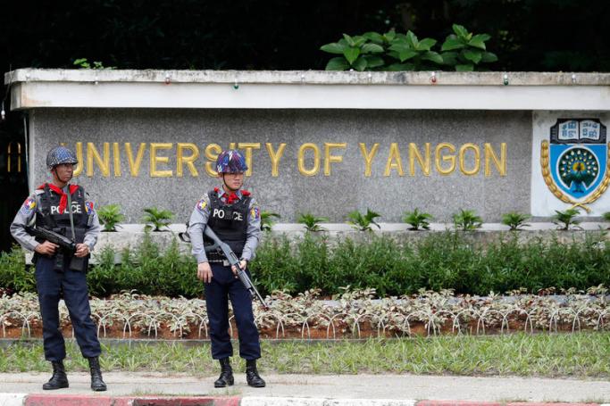 Armed police officers stand guard in Yangon. Photo: EPA