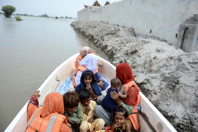 Rescue officials evacuate victims on a boat from flooded areas in Noora Nath, Pakpattan district, Punjab province, Pakistan, 23 August 2023. Photo: EPA