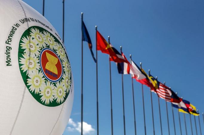 Balloon carrying the ASEAN logo stands next to ASEAN members and dialogue partners flags at the main venue of the Myanmar International Convention Center, 11 November 2014.Photo: Azhar Rahim/EPA
