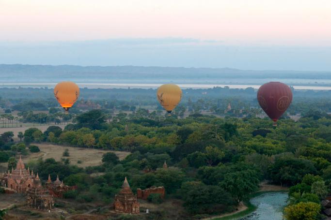 Balloons carrying visitors fly over temples during the sunrise in Bagan, the ancient temple city of Myanmar, Mandalay region, Myanmar. Photo: Nyein Chan Naing/EPA