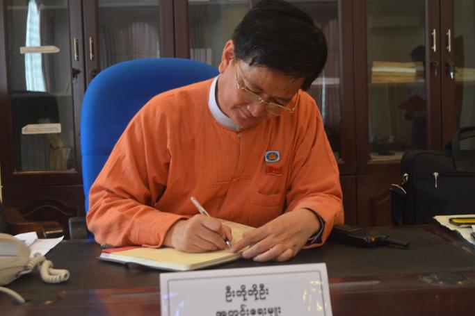 Bo Bo Oo, a Lower House MP representing the National League for Democracy party, works in an office in Nay Pyi Taw parliament. (Photo: Swe Win/Myanmar Now)
