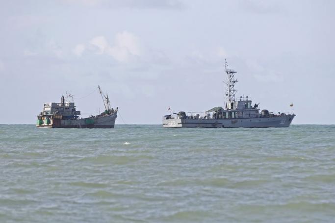 A picture made available on 01 June 2015 shows the boat of migrants (L) attached to a Myanmar Navy vessel anchored near the Thameehla island, Irrawaddy division, Myanmar, 31 May 2015. Photo: EPA

