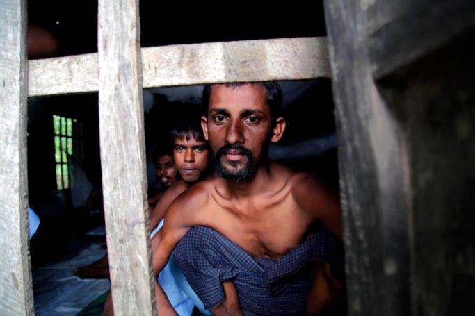 Rohingya Muslims from Bangladesh rescued by the Myanmar navy sit inside buildings at a temorary refugee camp in the village of Aletankyaw in the Maungdaw township of northern Rakhine state, Myanmar, 23 May 2015. Photo: Nyunt Win/EPA
