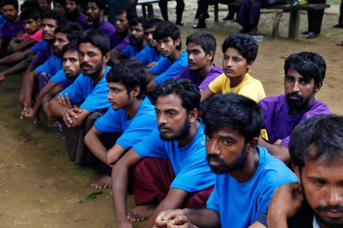 Rohingya Muslims from Bangladesh rescued by the Myanmar navy sit together at a temporary refugee camp in the village of Aletankyaw in the Maungdaw township of northern Rakhine state, Myanmar, 23 May 2015. Photo: Nyunt Win/EPA
