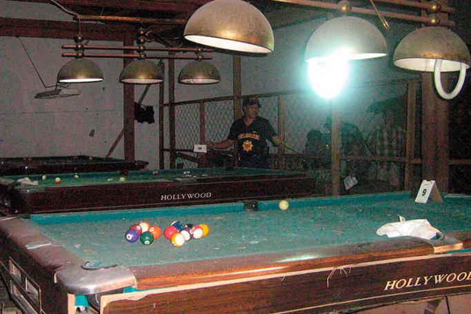 (File) A Philippine police investigator looks around a billiard hall near a public market where a homemade bomb exploded in Tacurong City of Sultan Kudarat province, 975 kilometres south of Manila, southern Philippines.
