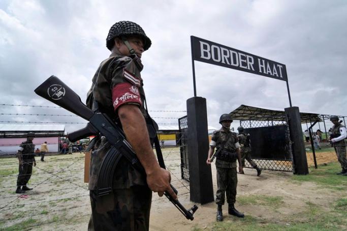 Bangladeshi Guards stand guard during the inauguration of the first Border Haat between India and Bangladesh in Kalaichar in Meghalay state, northeast India, 23 July 2011. Photo: EPA
