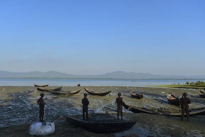 Border Guard Bangladesh (BGB) personel stand watch in a common transit point for the illegal entry of Myanmar Rohingya refugees on the banks of the Naf River, near Teknaf in southern Cox's Bazar district. Photo: AFP
