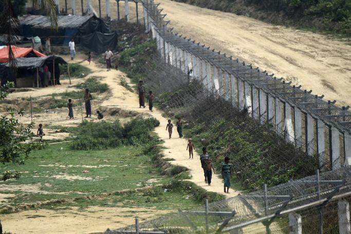 Rohingya refugees walk near their shelters in the "no man's land" behind Myanmar's border lined with barb wire fences in Maungdaw district, Rakhine state bounded by Bangladesh on April 25, 2018. Photo: Ye Aung Thu/AFP
