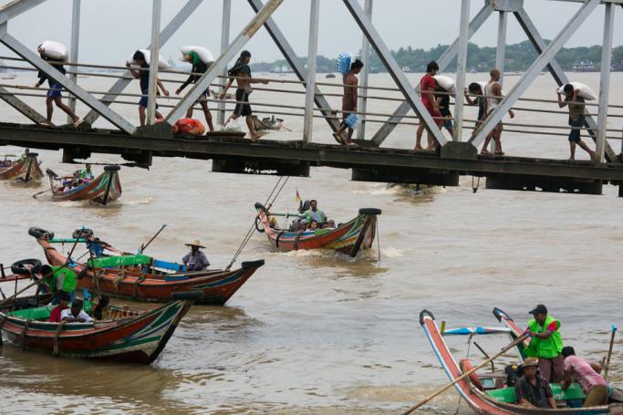 People from Dala township arriving by boat in Yangon after crossing the Yangon River. Photo: Sai Aung Main/AFP