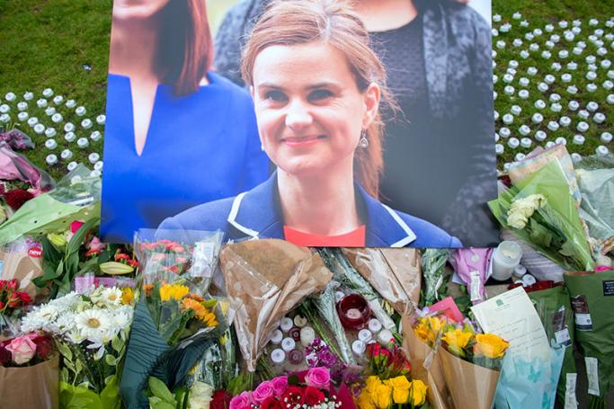 Floral tributes are left in memory near a photograph of British MP Jo Cox in Parliament Square, London, Britain, 17 June 2016. Photo: Hannah Mckay/EPA
