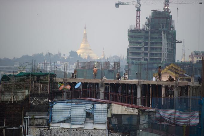 Construction laborers working on a building site in Yangon. Photo: Ye Aung Thu/AFP