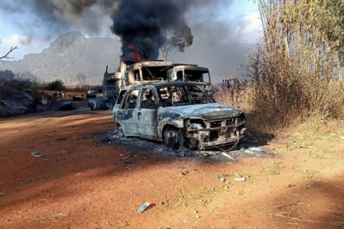  two burnt-out trucks and a car on a highway in Hpruso township (AFP/Handout)