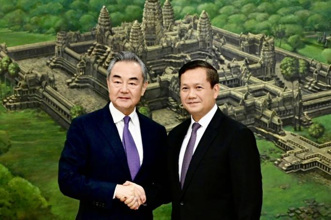 A handout photo made available by Government Cabinet shows Hun Sen's son Hun Manet, designated as Cambodia new Prime Minister (R) shaking hands with Chinese Foreign Minister Wang Yi (L), during a meeting at the Peace Palace in Phnom Penh, Cambodia, 13 August 2023. Photo: EPA