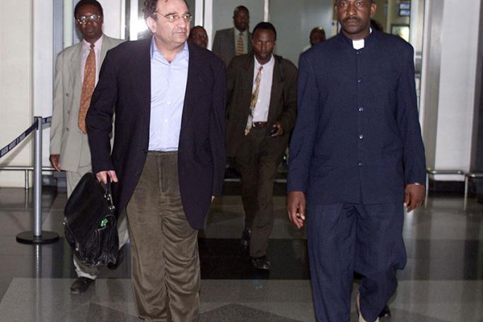 Former Israeli intelligence agent Ari Ben-Menashe (L) escorted by plain clothes policemen arrives at the Harare International Airport. Photo AFP 