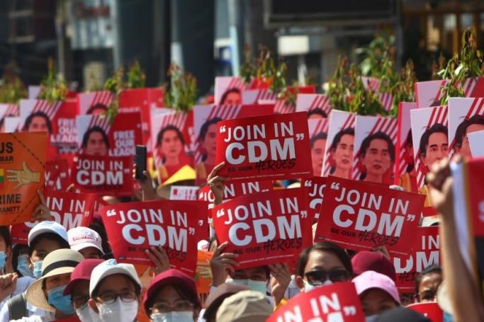File Photo: Anti-coup protesters hold up signs calling on others to join the CDM (Civil Disobedience Movement)