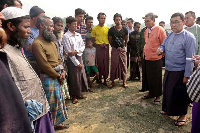 Myanmar Minister for Social Welfare, Relief and Resettlement Win Myat Aye (R) talks with people at a temporary camp in Maungdaw township, 14 January 2018. Photo: Nyunt Win/EPA-EFE
