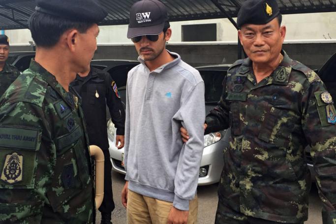 Royal Thai Army soldiers lead a suspect allegedly connected with the Erawan Shrine bombing after they arrested him in Sa Kaeo district, near the Thai-Cambodian border, 1 September 2015. Photo: EPA
