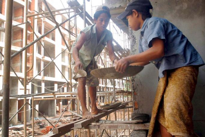 Child construction workers at work on a building site in Yangon. Photo: EPA