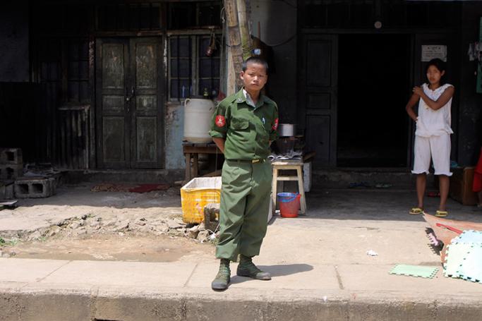 A file photo of a child soldier standing on a platform as a convoy carrying journalists and diplomats visit the Myanmar-China border town Laukkai, Myanmar on 8 September 2009. Photo: EPA

