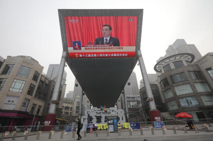 A large screen displays Chinese Premier Li Keqiang delivering a speech during the opening session of the National People's Congress (NPC), in Beijing, China, 05 March 2021. Photo: EPA