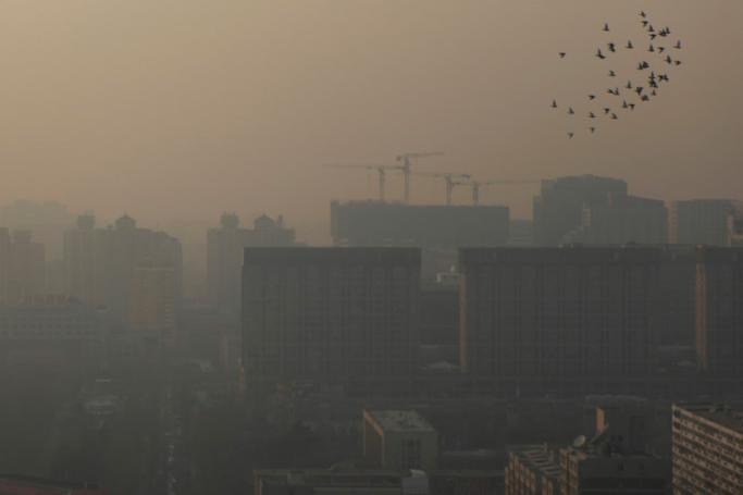 (File) A view of buildings shrouded in smog in the capital city of Beijing, China. Photo: EPA